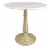 Round white marble tabletop with subtle gray veining atop a gold-toned pedestal base.
