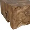 Close-up of rough, squared timber blocks stacked together, showcasing natural wood grain, knots, and visible joints.