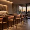 Modern bar interior with a wooden counter, stone walls, and warm sunset lighting.|Informative image of an upscale bar interior at dusk