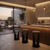 Modern kitchen interior with a marble-like wall, backlit ceiling, and three glass pendant lights above a wooden island.