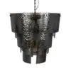 Hammered black metal pendant lamp shade hanging from a chain, close-up view