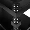 Close-up of a glossy black table leg with turned shapes, reflected in a mirrored surface below.