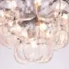 Close-up of a glass bubble chandelier with warm lights glowing from within the transparent spheres.