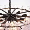 Close-up of a metal chandelier with multiple lit bulbs and ice-like panels surrounding it on a frosty backdrop