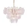 Crystal chandelier with layered clear glass leaf-shaped panels suspended from a brass chain, lit softly.