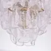 Close-up of a glass chandelier with hanging crystal teardrops.