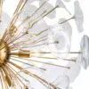 Close-up of a modern glass-and-gold chandelier with overlapping glass discs and gold rods.
