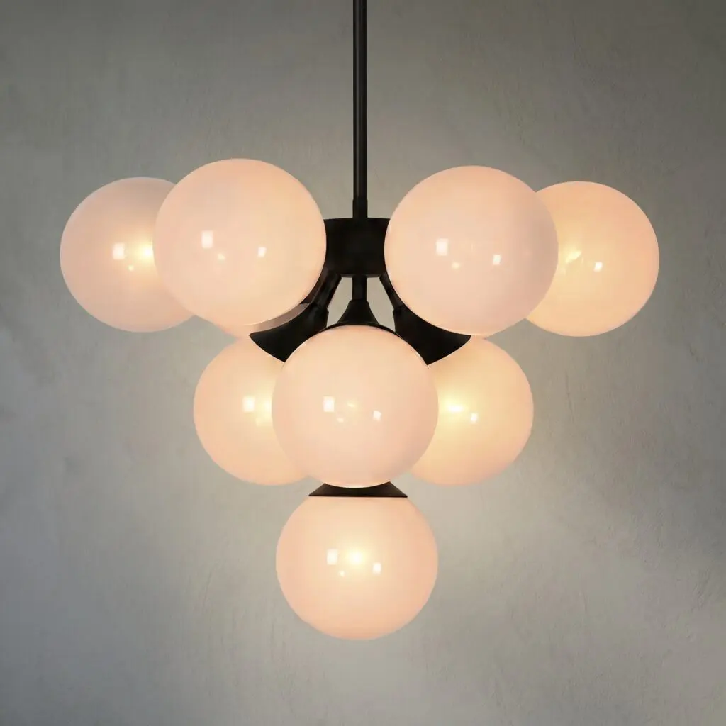 Pendant chandelier with multiple frosted glass globes hanging from a chain, emitting warm light.
