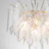 Close-up of a crystal chandelier with diamond-shaped glass prisms and gold accents hanging from a chain.