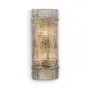 Close-up of a textured metallic cylindrical object with a diamond-shaped, faceted pattern in gold and silver tones