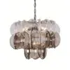 Metallic chandelier composed of overlapping circular discs suspended from a chain in silver and bronze tones