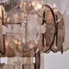Close-up of overlapping translucent glass discs forming a decorative chandelier centerpiece.