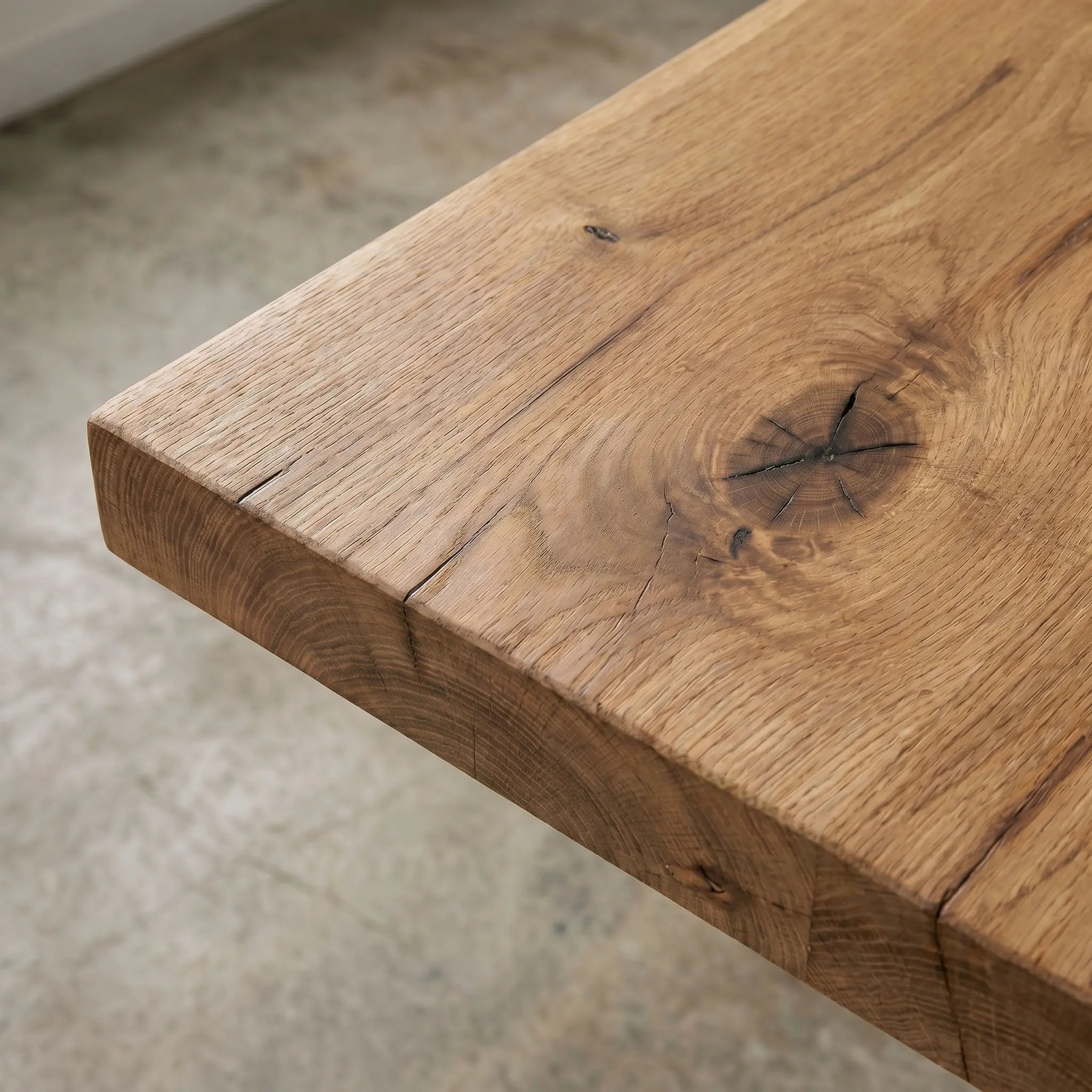 Natural grain and hand finish variation in Noir furniture