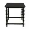 Black square side table with bold, turned legs and lower crossbar, minimalist modern design