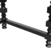 Close-up of a black metal bed/table frame corner with a crossbar and decorative turned posts on either side.
