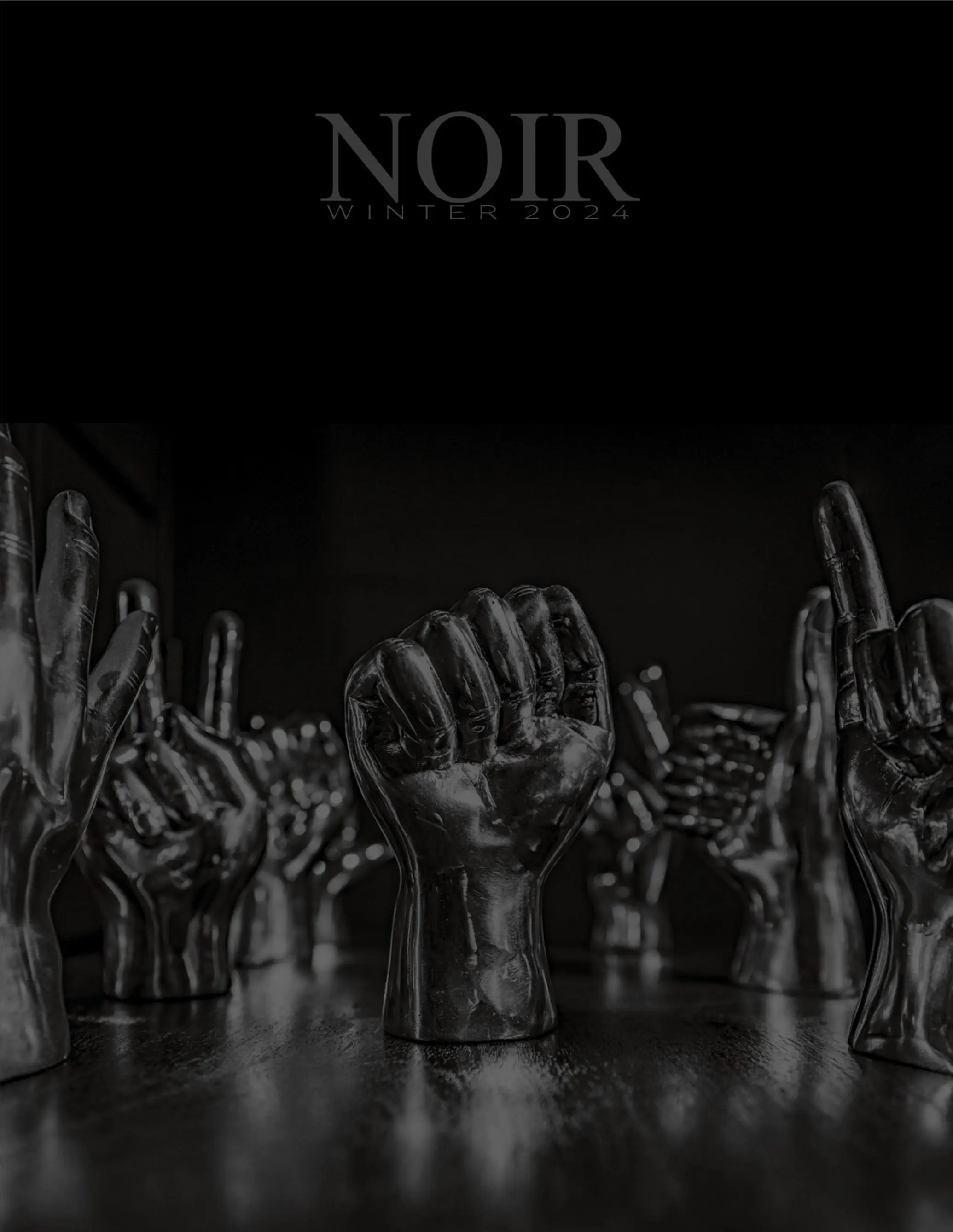 Group of glossy black hands reaching upward from a dark surface, like an art installation or sculpture piece at night.