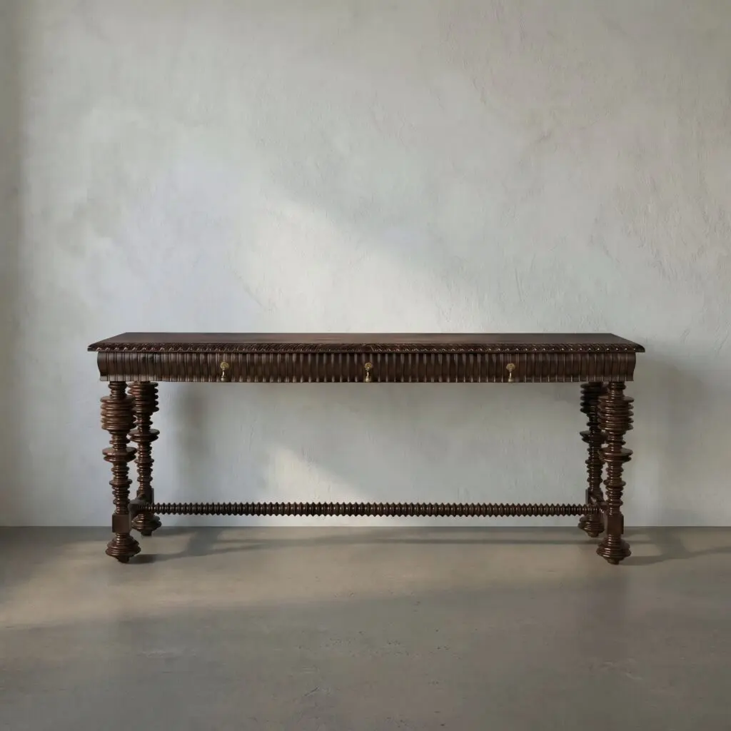 Antique carved wooden coffin resting on tall, spiraled pedestals against a plain textured wall.