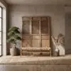 Indoor scene with beige walls and a tall wooden cabinet featuring lattice panels, plus a bonsai on the left and dried grasses on the right.
