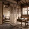 Traditional Japanese-style room with wooden framework, lattice screens, and low wooden furniture.