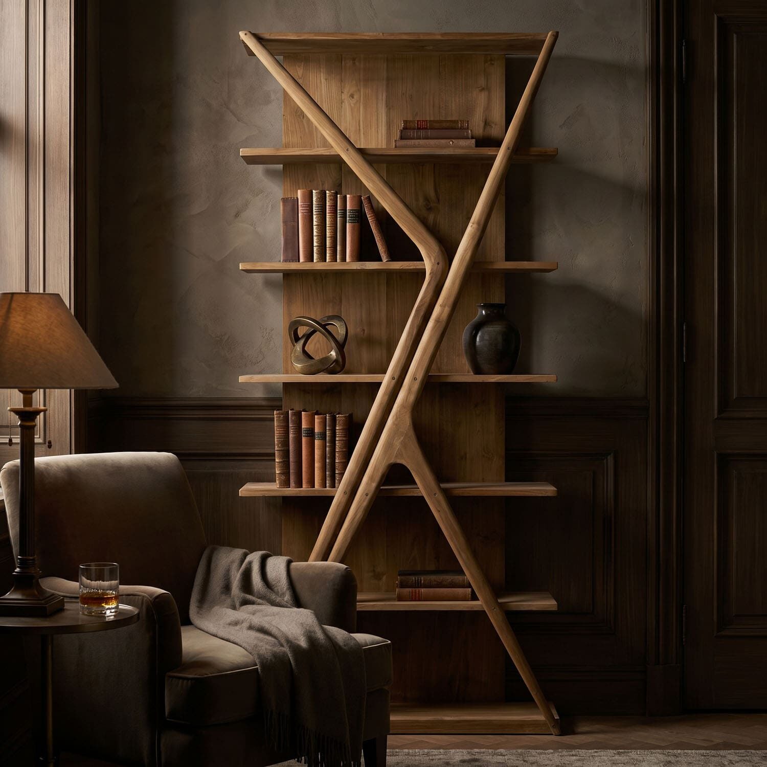 Cozy reading nook with a wooden ladder-style bookshelf, warm lamp, and an armchair with a blanket woven over it.